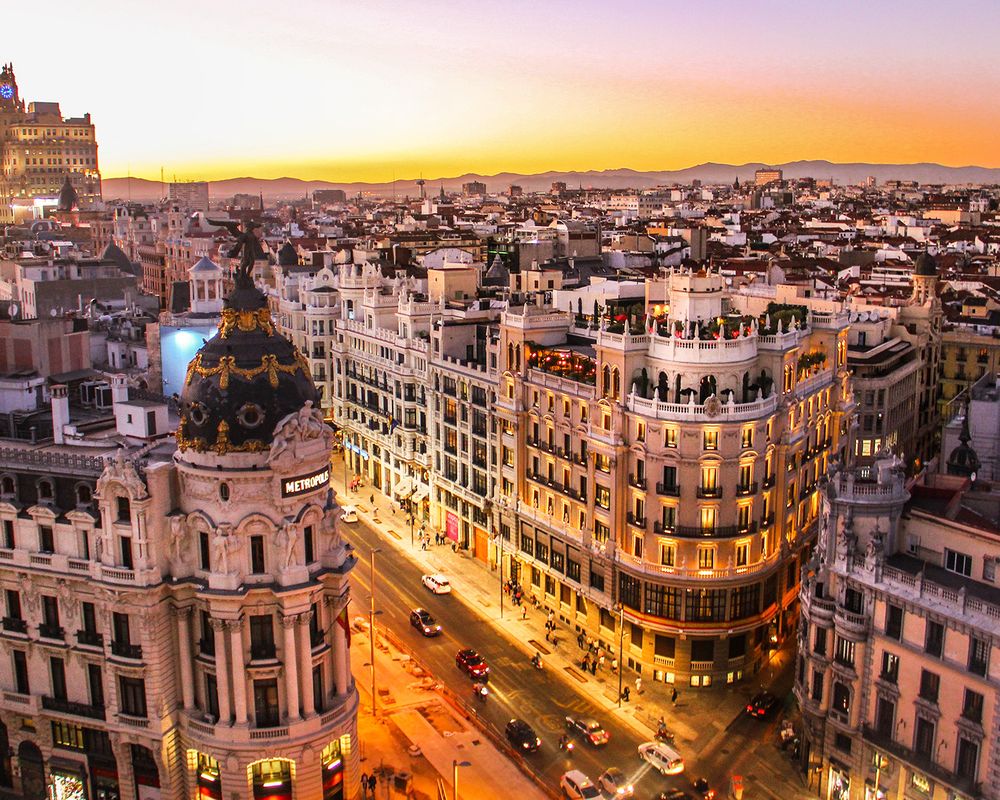 Golden sunset over the rooftops and grand avenues of Madrid, Spain